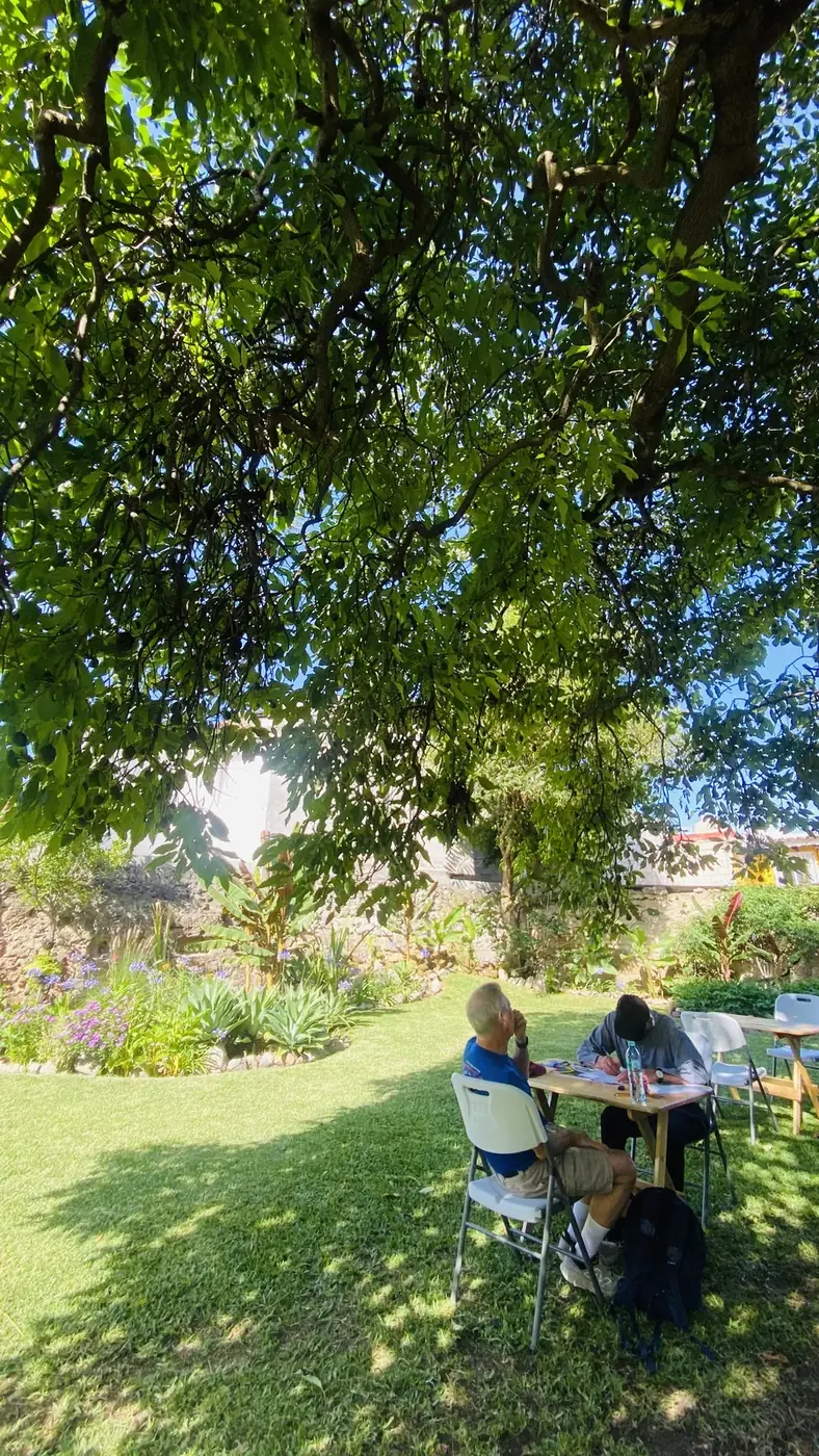Students having a Spanish lesson in a garden at Spanish Antigua