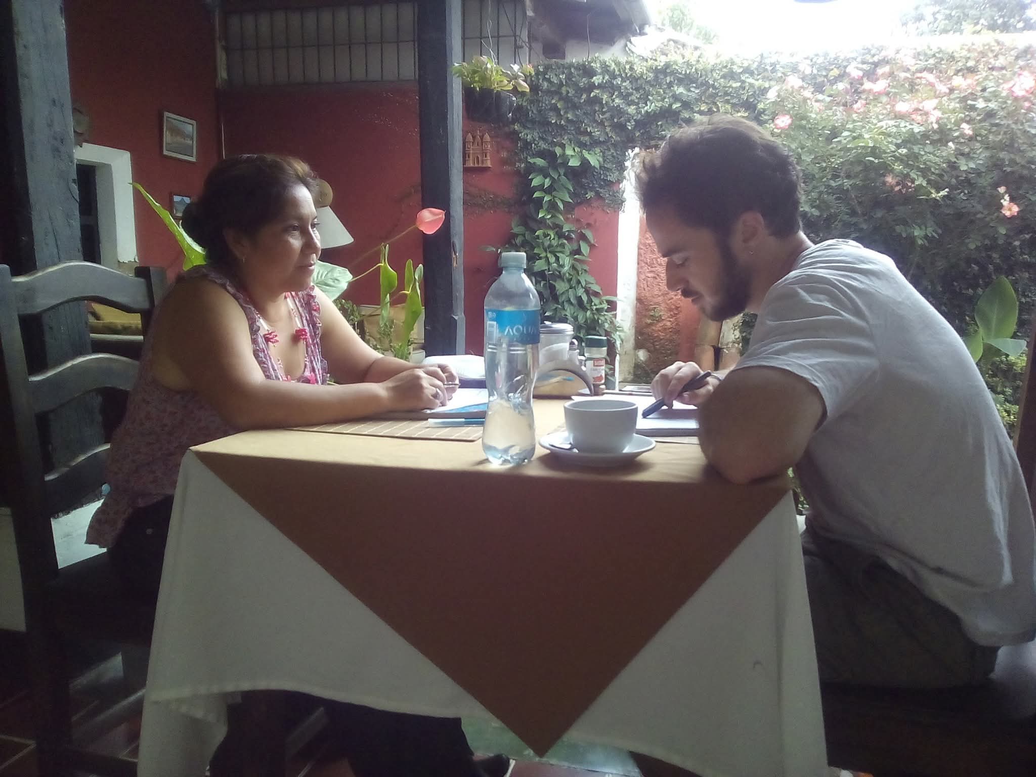 Students, teachers and a host family at Spanish Antigua celebrating a course completion certificate in Antigua Guatemala